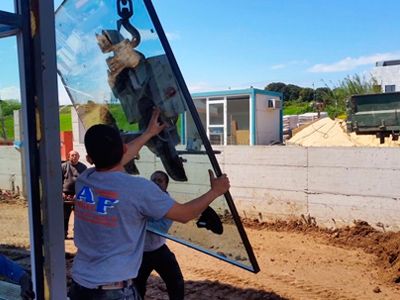 Carpintería Metálica Ángel Fernández hombres instalando vidrio